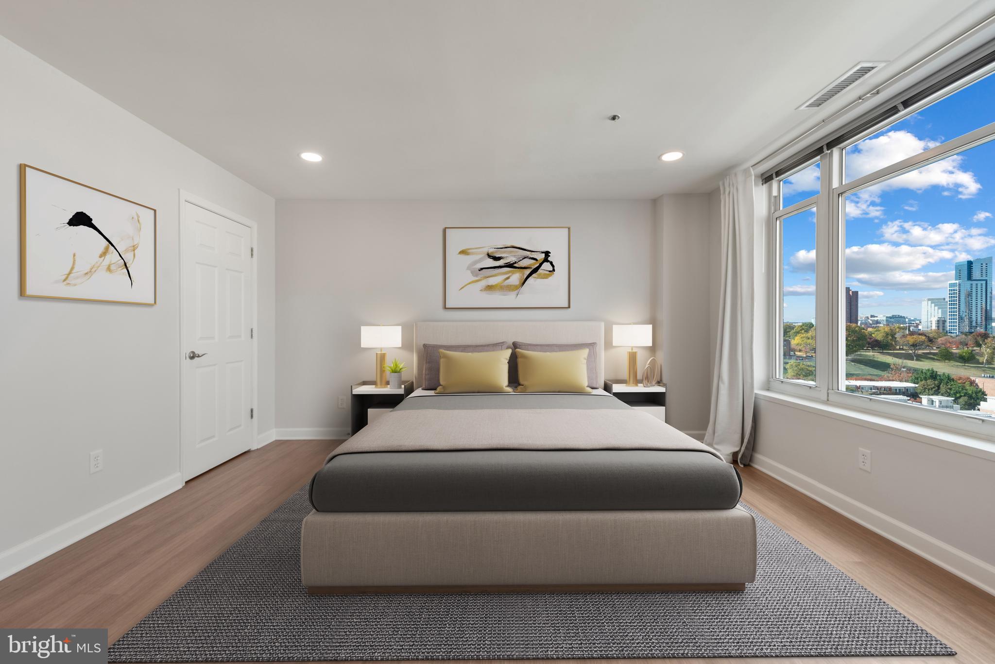 100 Harborview Drive, Unit 1209 Baltimore, MD 21230 - Photo 12 of 43 a bedroom with a large bed and a large window