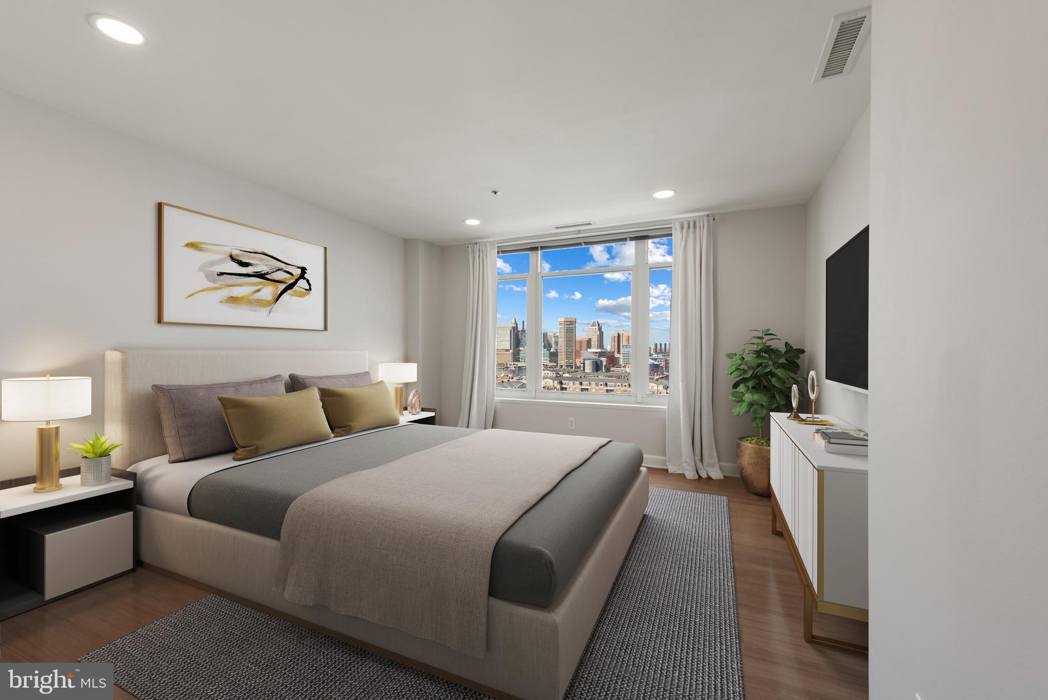 100 Harborview Drive, Unit 1209 Baltimore, MD 21230 - Photo 13 of 43 a bedroom with a large bed and a couch