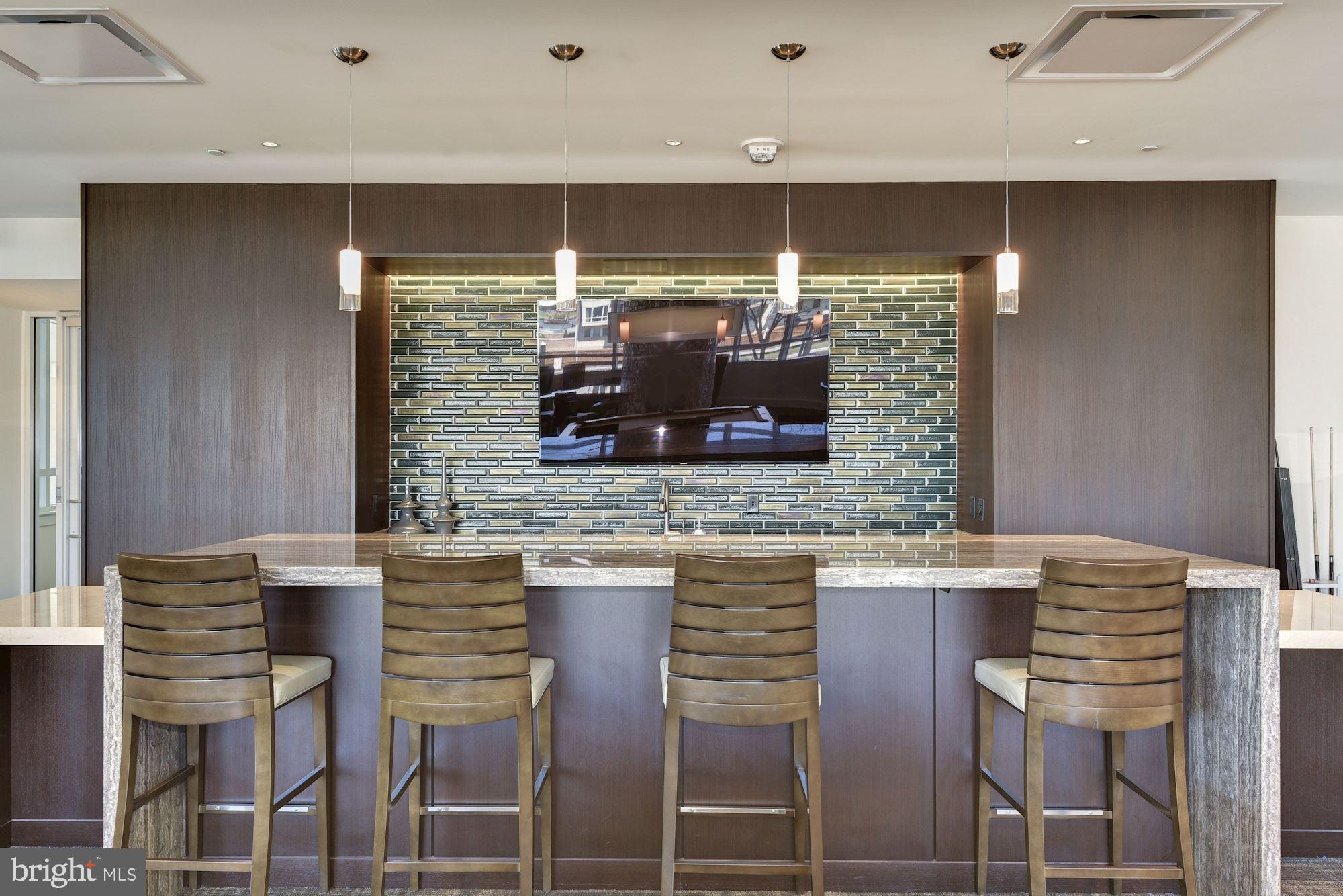 100 Harborview Drive, Unit 1209 Baltimore, MD 21230 - Photo 23 of 43 a kitchen with a table and chairs in it