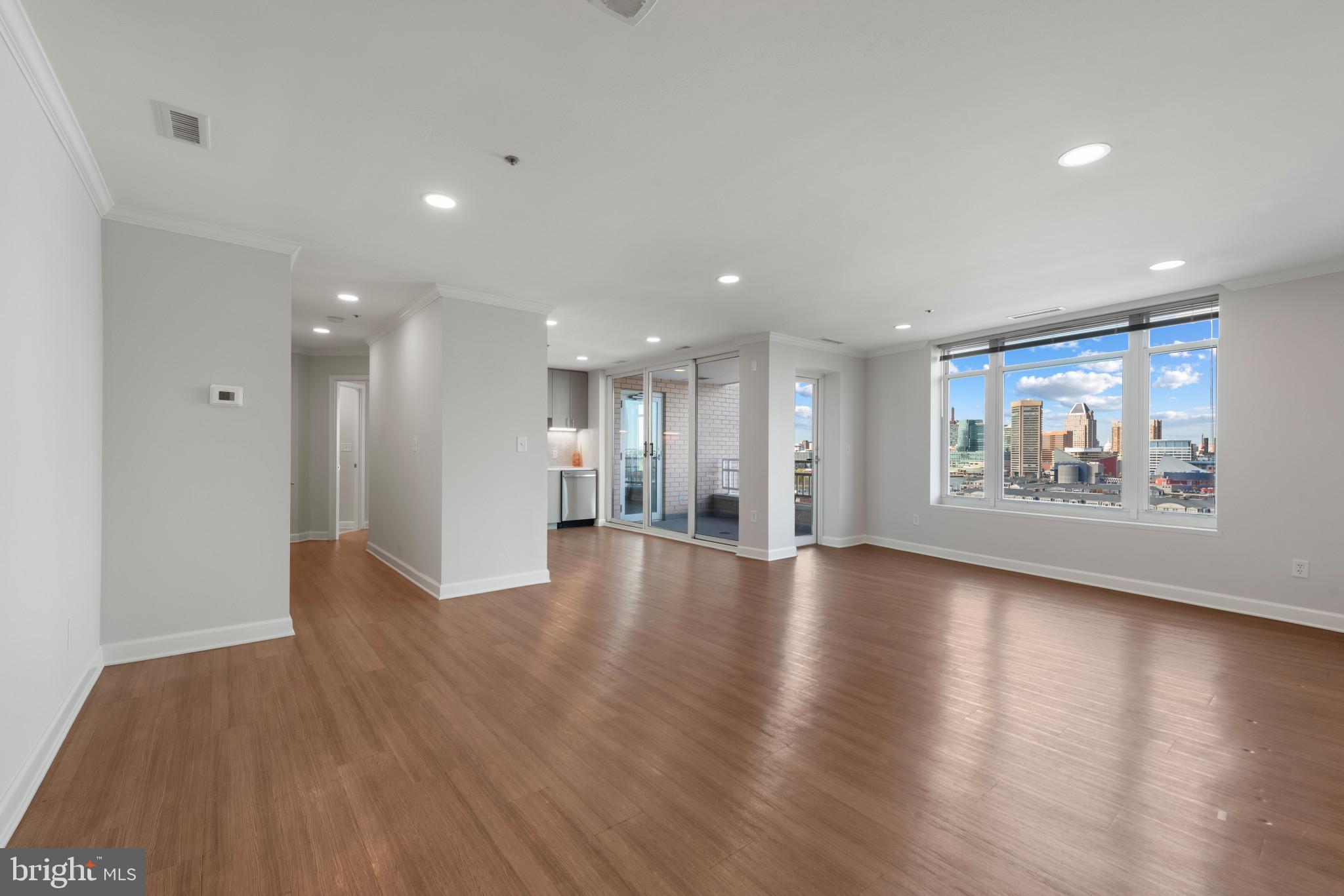 100 Harborview Drive, Unit 1209 Baltimore, MD 21230 - Photo 35 of 43 a view of an empty room with wooden floor and a window