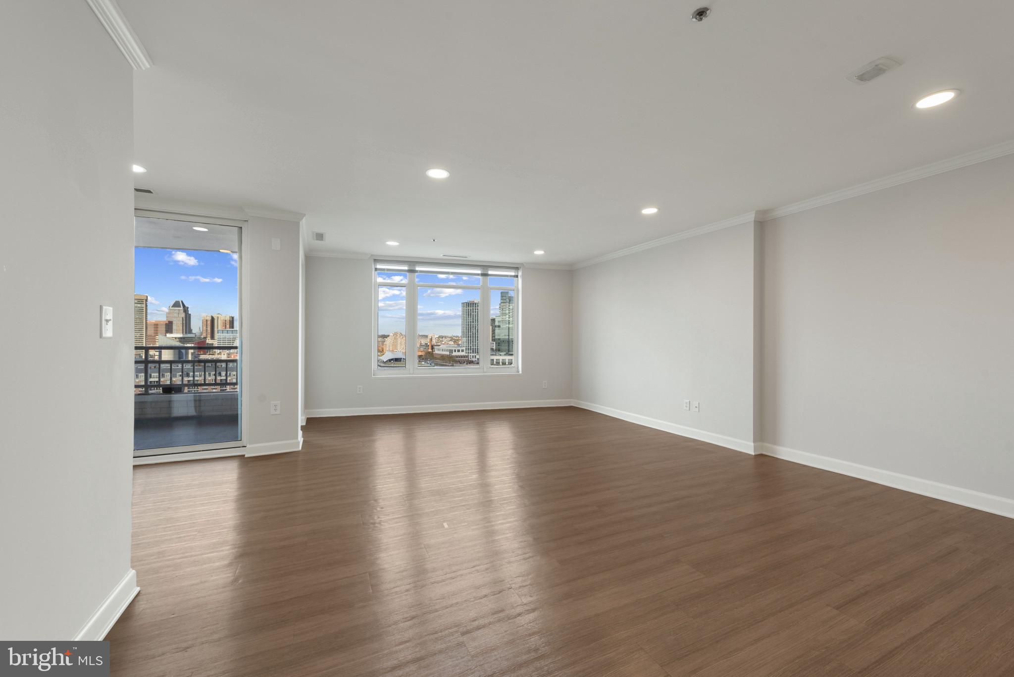 100 Harborview Drive, Unit 1209 Baltimore, MD 21230 - Photo 36 of 43 a view of a big room with wooden floor and windows