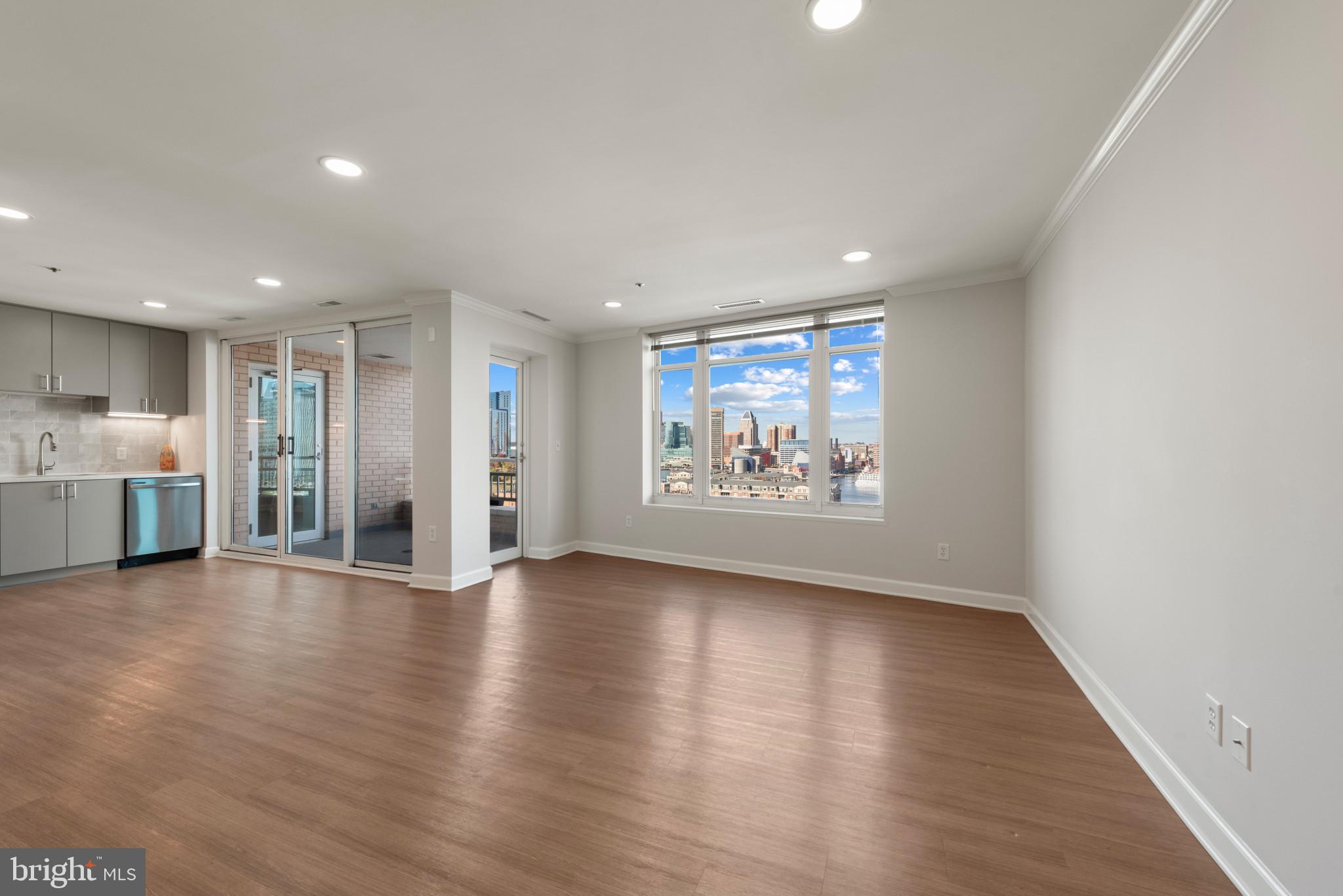 100 Harborview Drive, Unit 1209 Baltimore, MD 21230 - Photo 37 of 43 a view of an empty room with wooden floor
