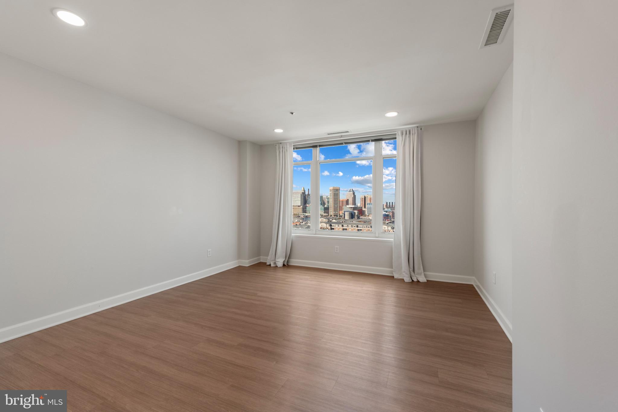 100 Harborview Drive, Unit 1209 Baltimore, MD 21230 - Photo 40 of 43 a view of a room with wooden floor and window