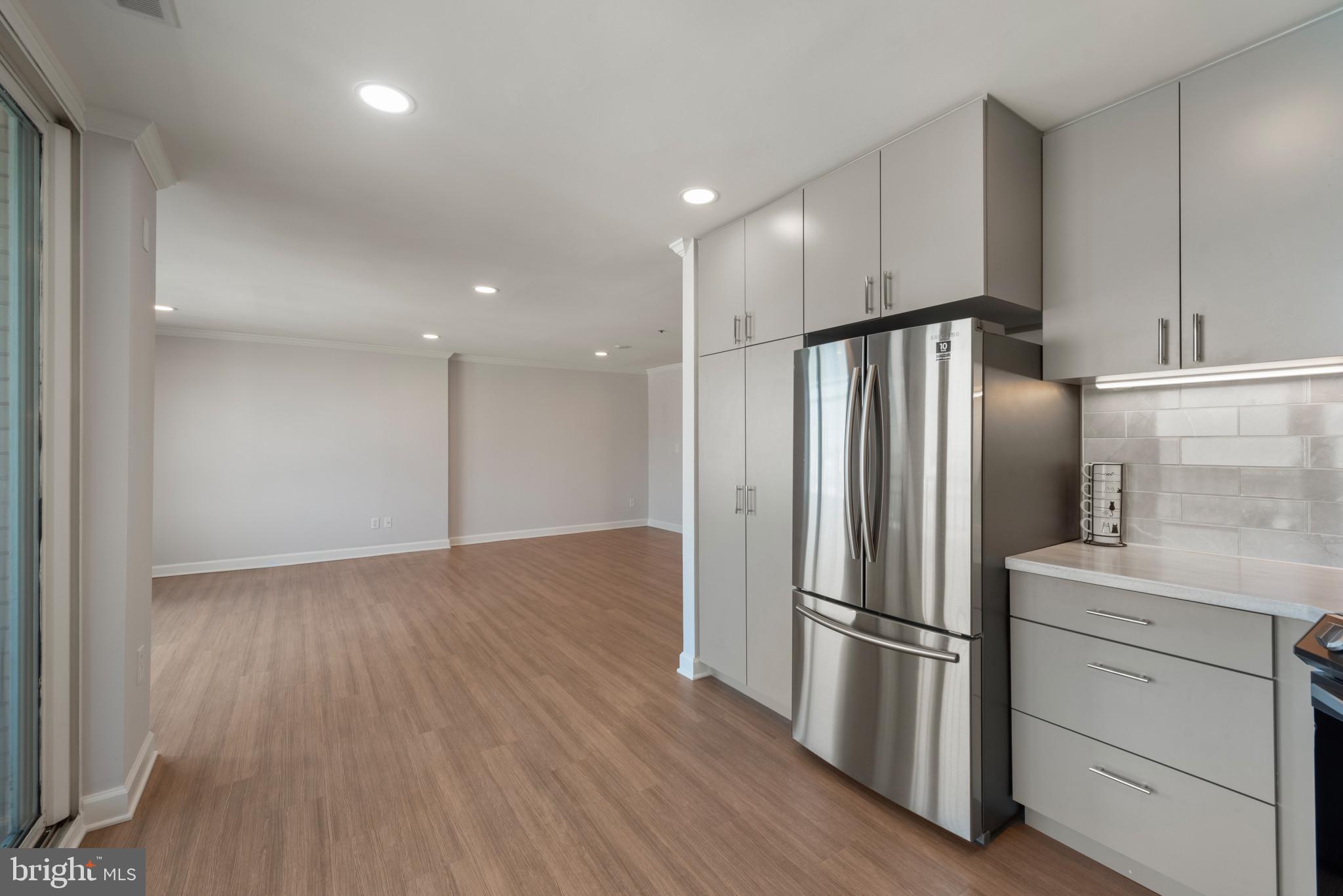 100 Harborview Drive, Unit 1209 Baltimore, MD 21230 - Photo 7 of 43 a kitchen with stainless steel appliances a refrigerator sink and cabinets