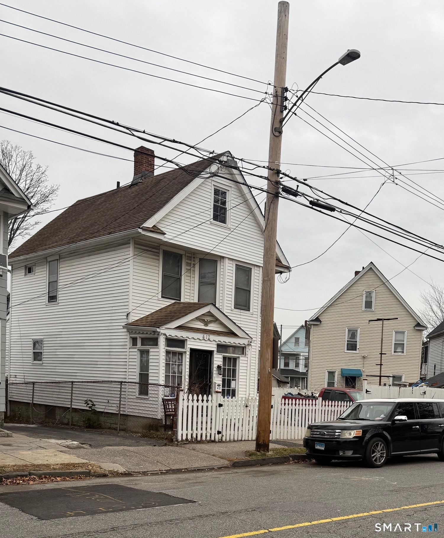 412 Dewey Street Bridgeport, CT 06605 - Photo 3 of 10 a front view of a house with a small yard