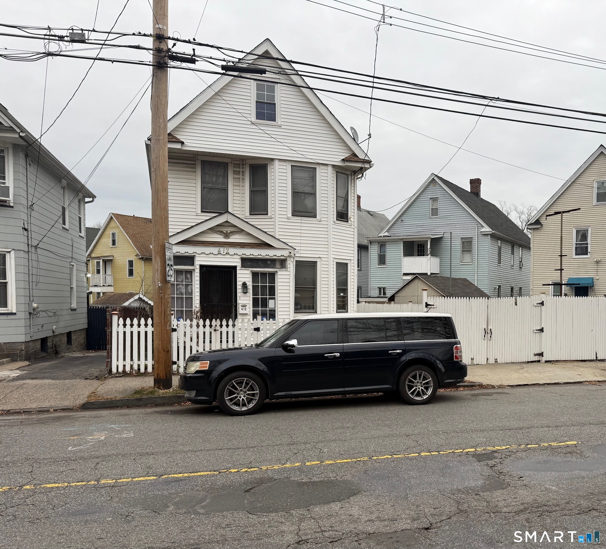 412 Dewey Street Bridgeport, CT 06605 - Photo 4 of 10 a car parked in front of a house