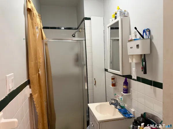 a bathroom with a sink toilet and shower