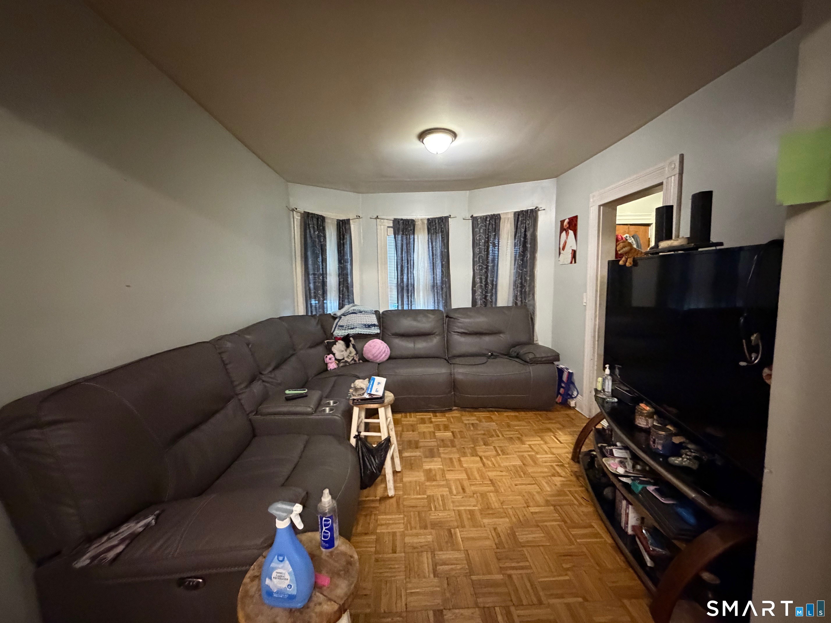 412 Dewey Street Bridgeport, CT 06605 - Photo 10 of 10 a living room with furniture and a flat screen tv
