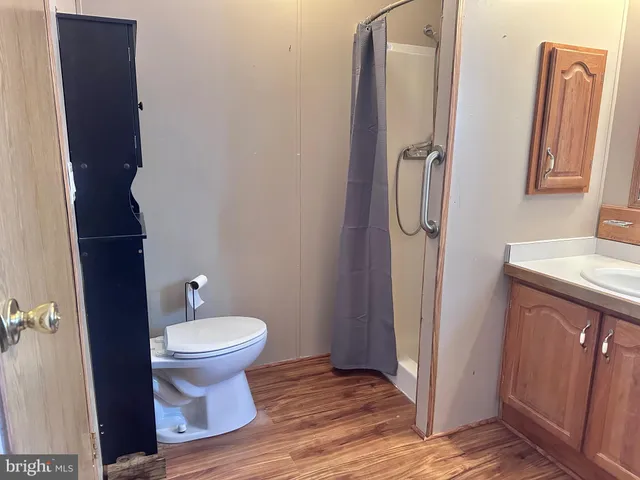 a bathroom with a toilet and a mirror
