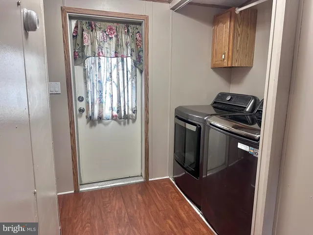 a kitchen with a refrigerator and a stove top oven
