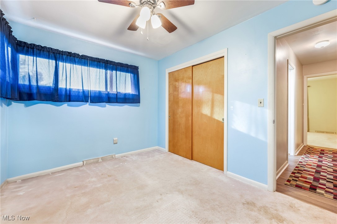 844 Roseland Road Alliance, OH 44601 - Photo 32 of 40 Unfurnished bedroom featuring a closet, ceiling fan, and carpet