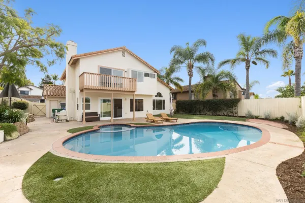 a view of a house with swimming pool and sitting area