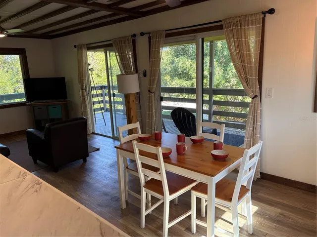 a view of a dining room with furniture window and outside view