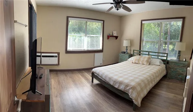 a bedroom with a bed and a ceiling fan
