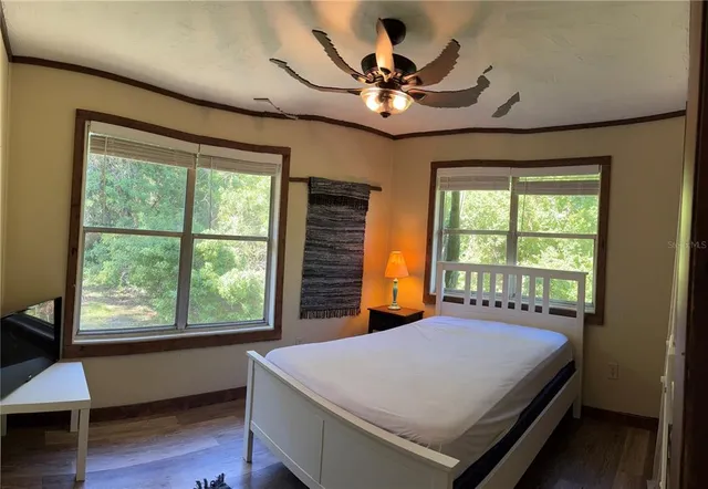 a bedroom with a bed and a window