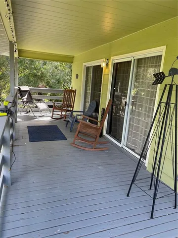 a view of a living room with wooden floor and furniture