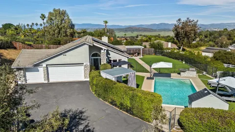 aerial view of a house with a yard