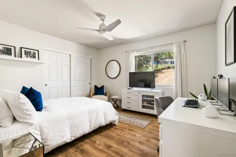 a bedroom with a bed and a chair