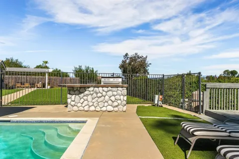 an aerial view of residential house with outdoor space and trees