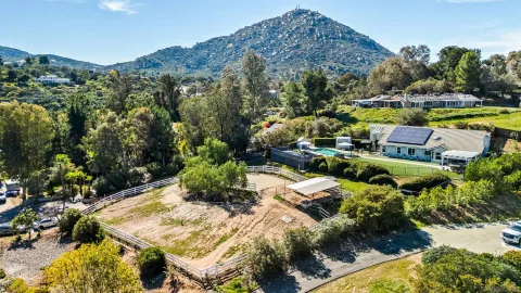 an aerial view of a house with a big yard