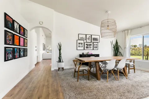 a view of a dining room with furniture window and wooden floor