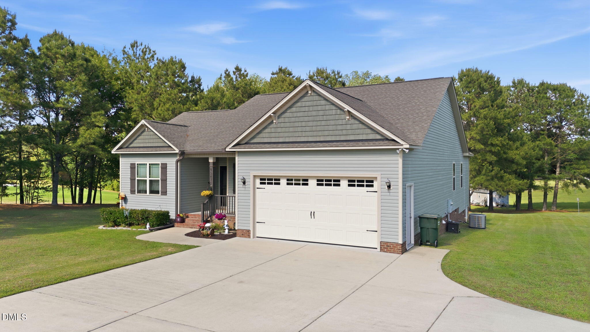 1547 Lassiter Pond Road Four Oaks, NC 27524 - Photo 3 of 45 a front view of a house with a yard and trees