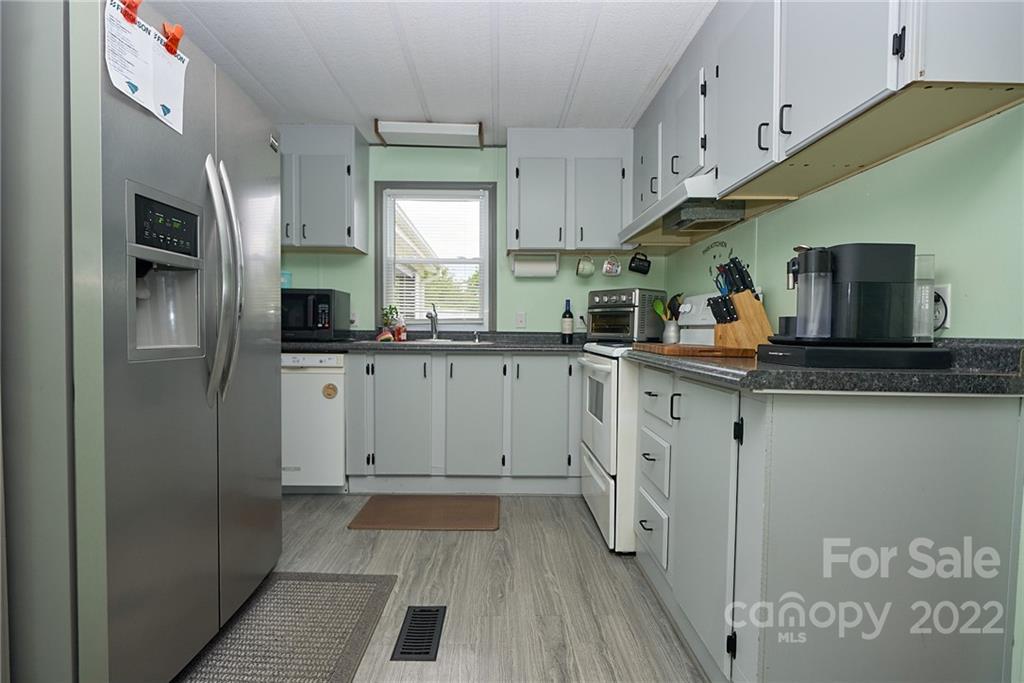 6781 Wright Road Kannapolis, NC 28081 - Photo 16 of 23 a kitchen with stainless steel appliances a sink stove refrigerator and cabinets