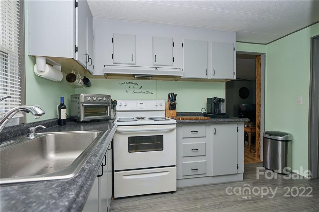 6781 Wright Road Kannapolis, NC 28081 - Photo 17 of 23 a kitchen with white cabinets and white appliances