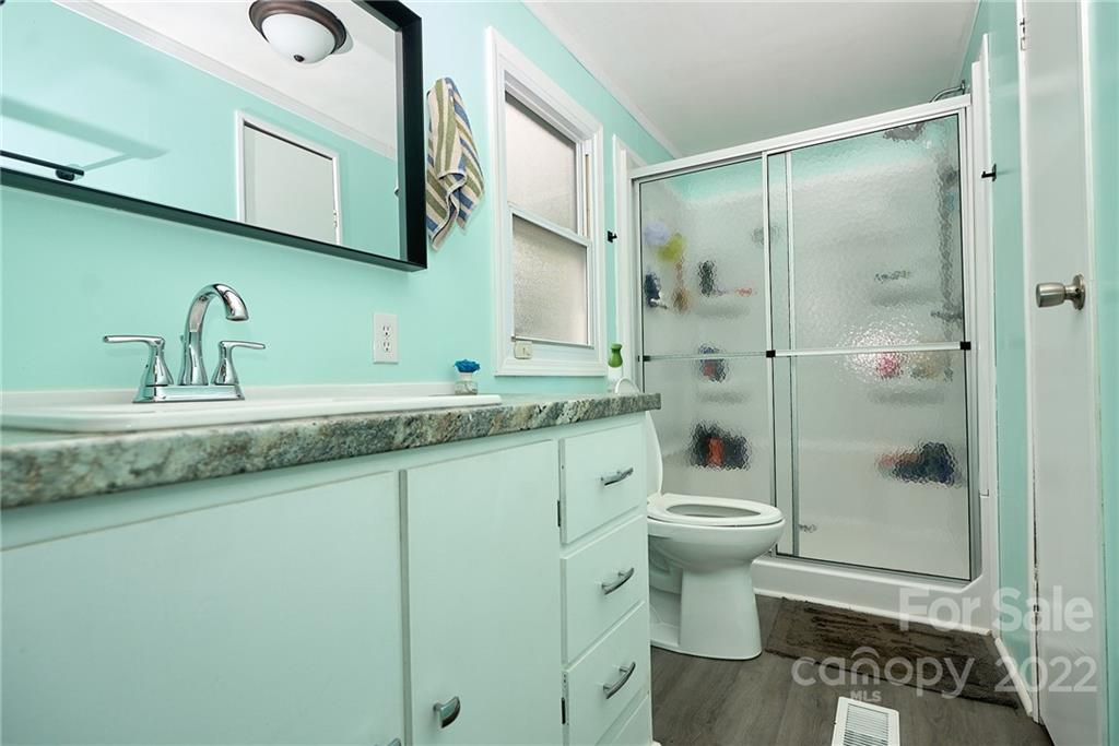 6781 Wright Road Kannapolis, NC 28081 - Photo 20 of 23 a bathroom with a granite countertop sink toilet and shower