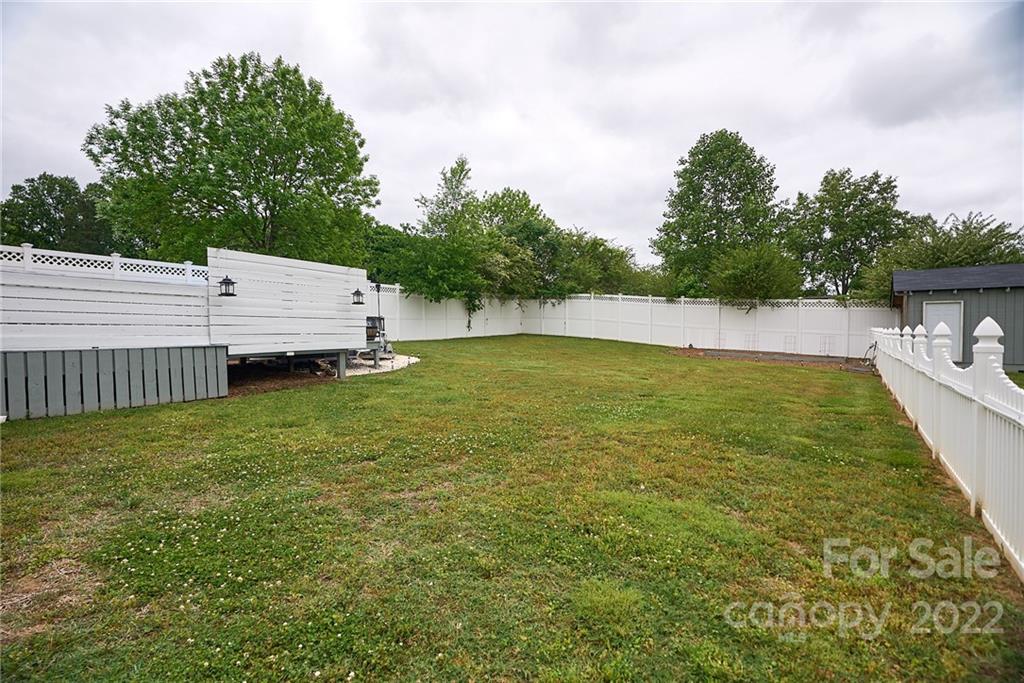 6781 Wright Road Kannapolis, NC 28081 - Photo 8 of 23 a view of a swimming pool with a chair and a small yard