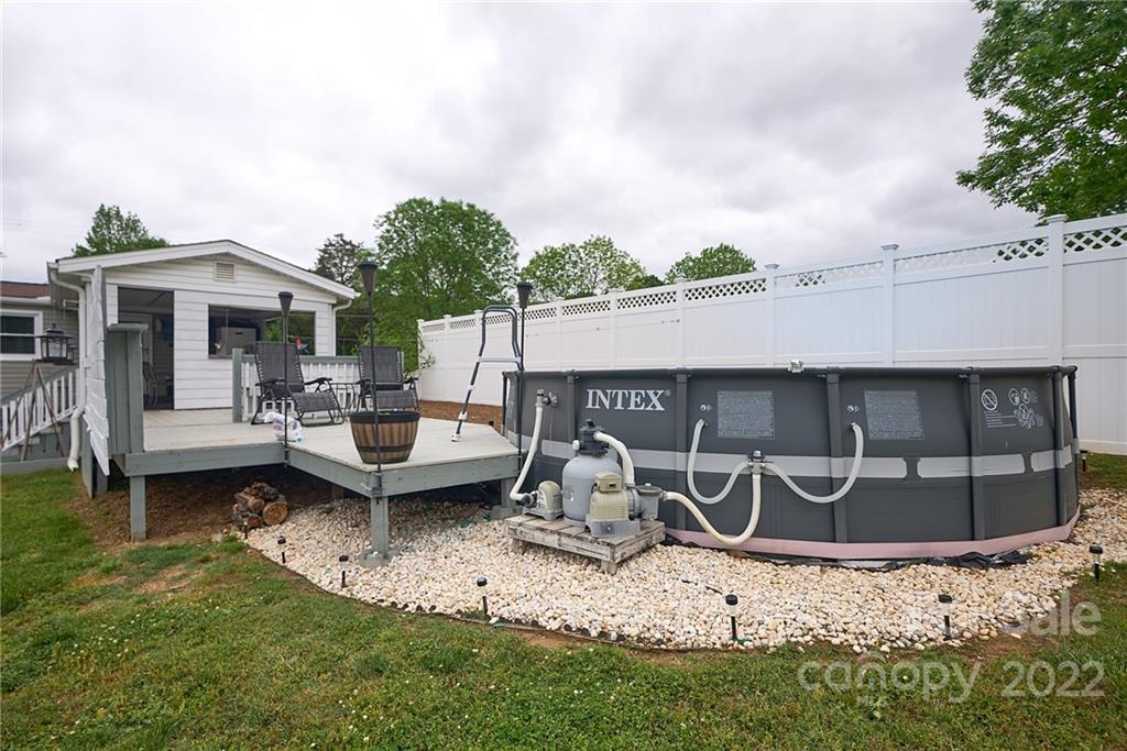 6781 Wright Road Kannapolis, NC 28081 - Photo 9 of 23 a view of a patio with table and chairs a barbeque with wooden fence
