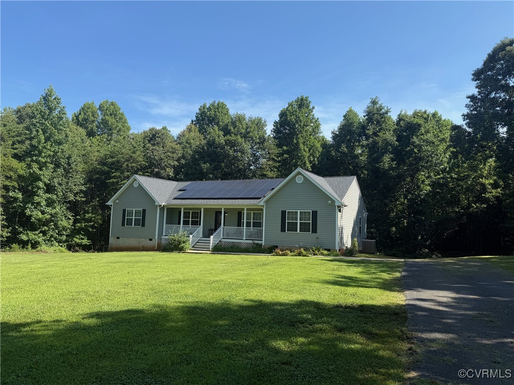 a front view of a house with yard and green space