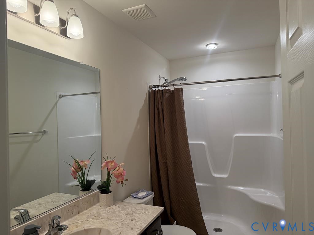 2095 Five Forks Road Pamplin, VA 23958 - Photo 21 of 23 a bathroom with a shower a sink and toilet