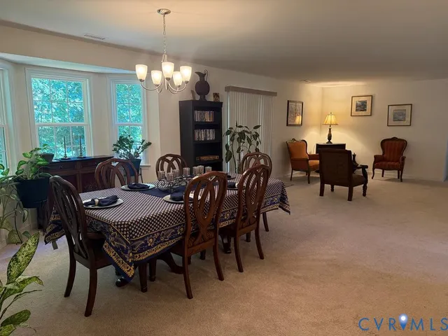 a view of a dining room with furniture and window