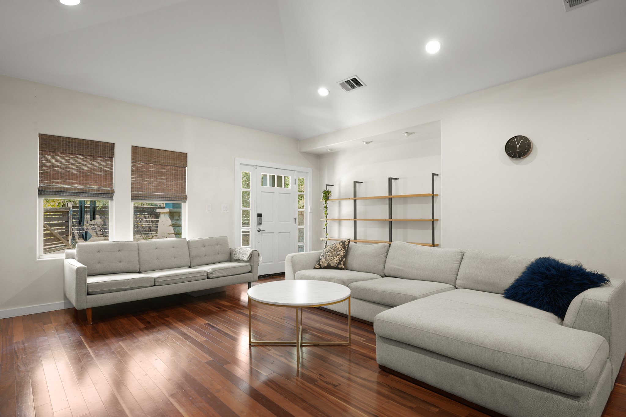Gleaming hardwood floors and a vaulted ceiling anchor this inviting living space.