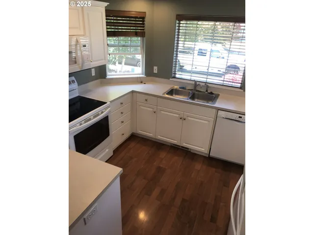 a kitchen with stainless steel appliances a sink and a window