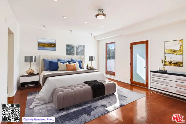 a spacious bedroom with a bed and wooden floor