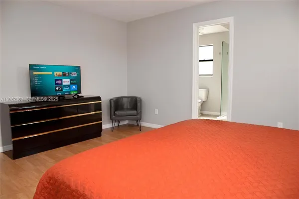 a bedroom with a bed and a flat screen tv