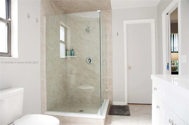 a bathroom with a shower and a toilet
