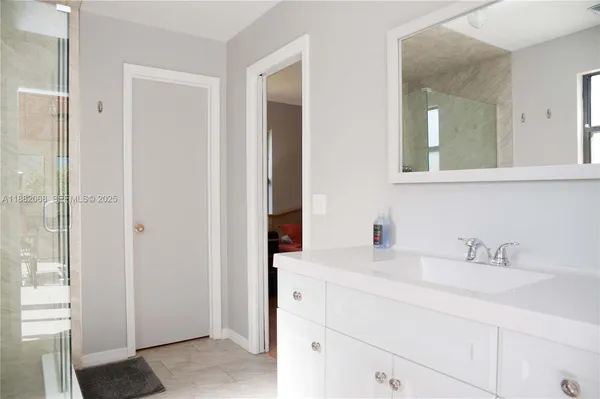a bathroom with a sink and a mirror