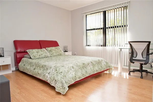 a bedroom with a bed chair and window