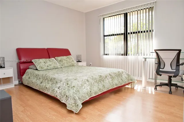 a bedroom with a bed chair and window