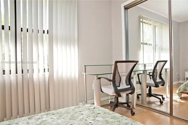 a view of a dining room with furniture and a window