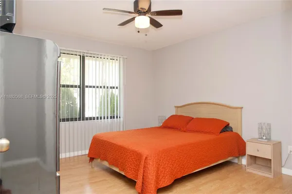 a bedroom with a bed and window