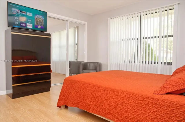 a bedroom with a bed and a painting on the wall