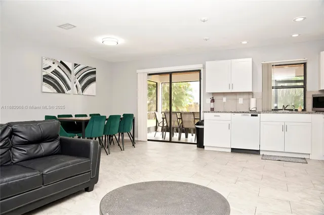 a living room with furniture and kitchen view