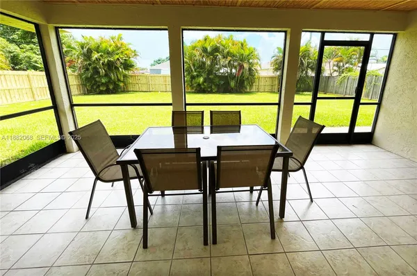a view of a dining room with furniture and a large window