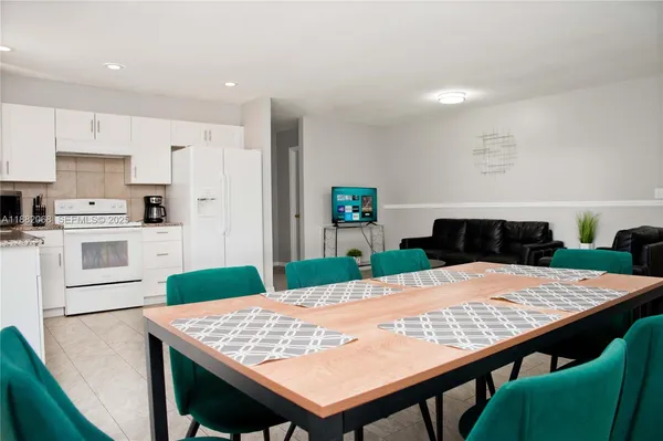 a large kitchen with a table and chairs