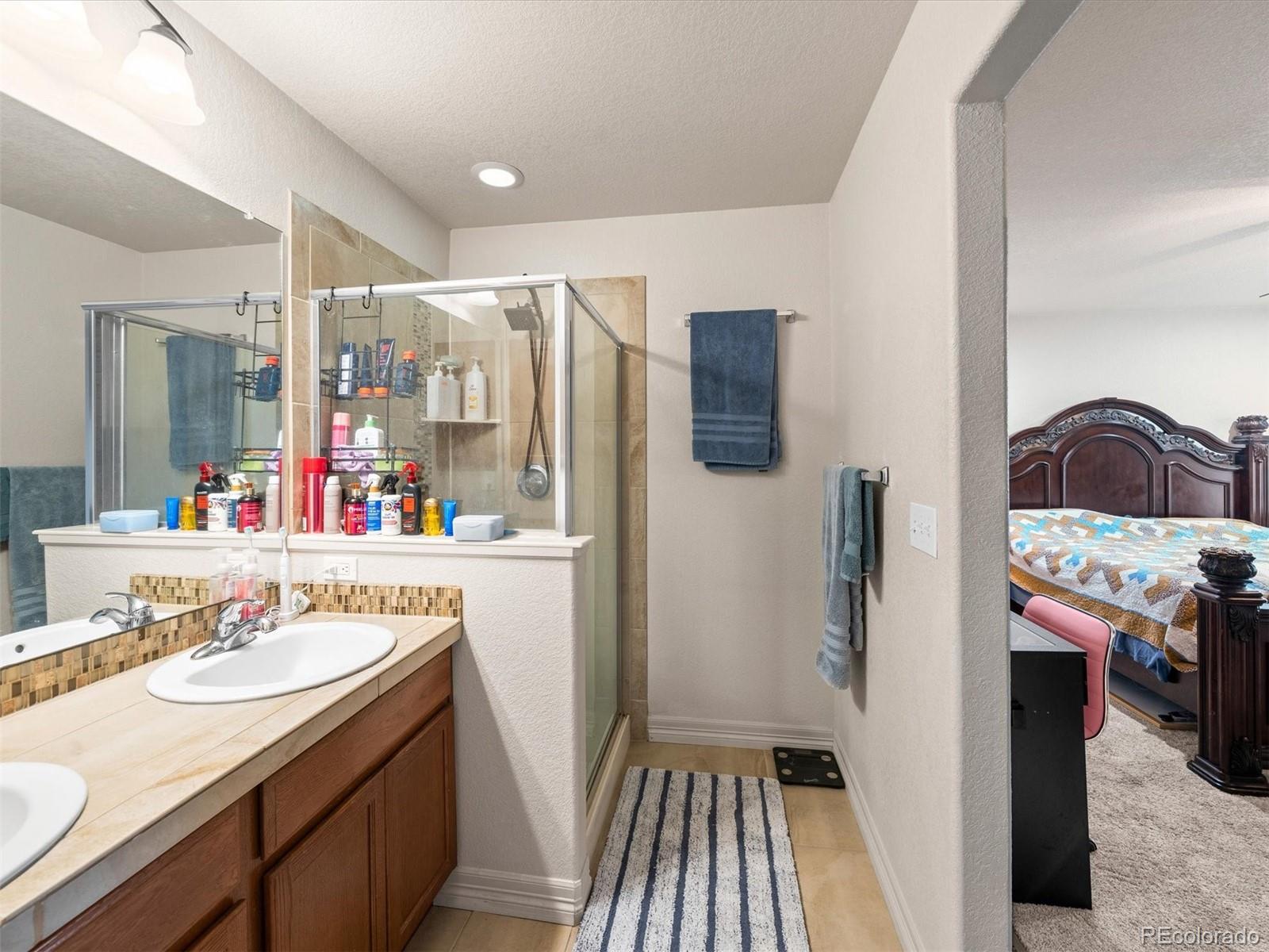 1940 Basil Street Strasburg, CO 80136 - Photo 20 of 38 a bathroom with a sink and a mirror