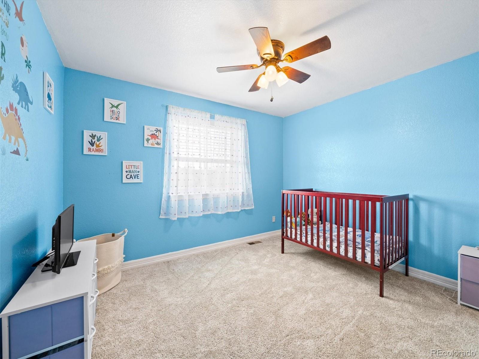 1940 Basil Street Strasburg, CO 80136 - Photo 26 of 38 a view of livingroom with furniture and ceiling fan